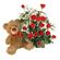 Teddy Bear & Roses. A charming teddy bear and and arrangement of tender red roses with greens in basket.